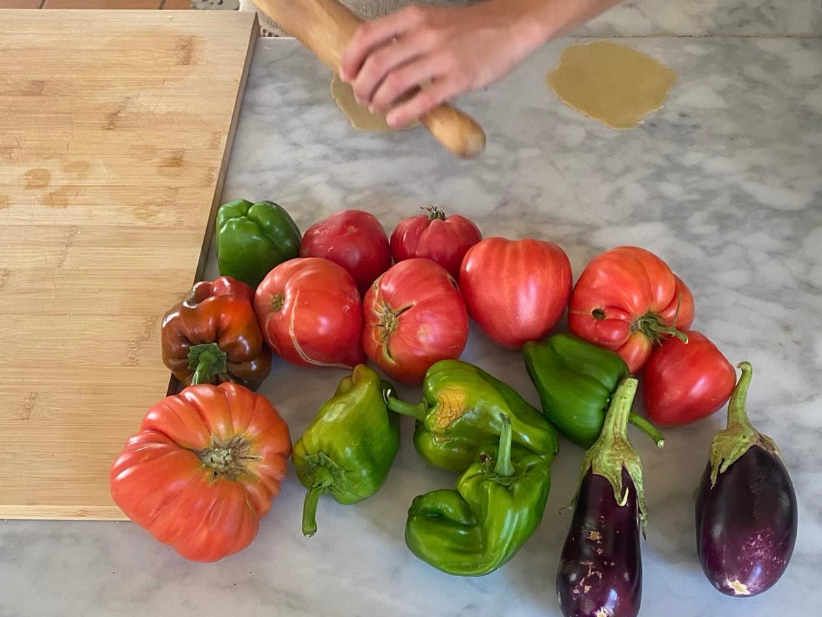 Tomatoes and peppers on a marble counter